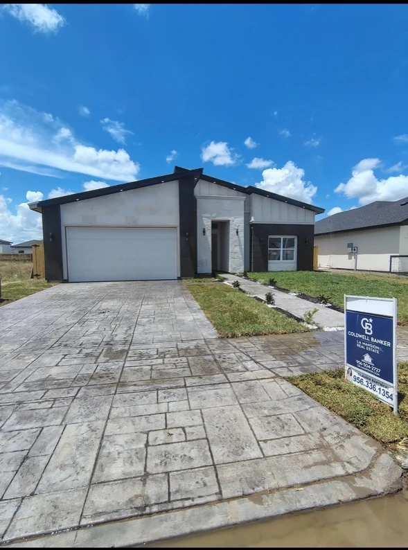 Home exterior with a stamped concrete driveway and walkway.
