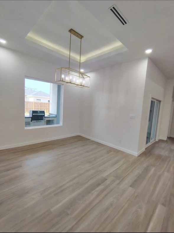 Interior living area with wood-tone floors and natural light.
