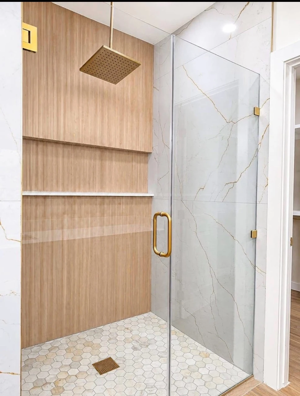 Shower with a wood-slat panel and light tile.