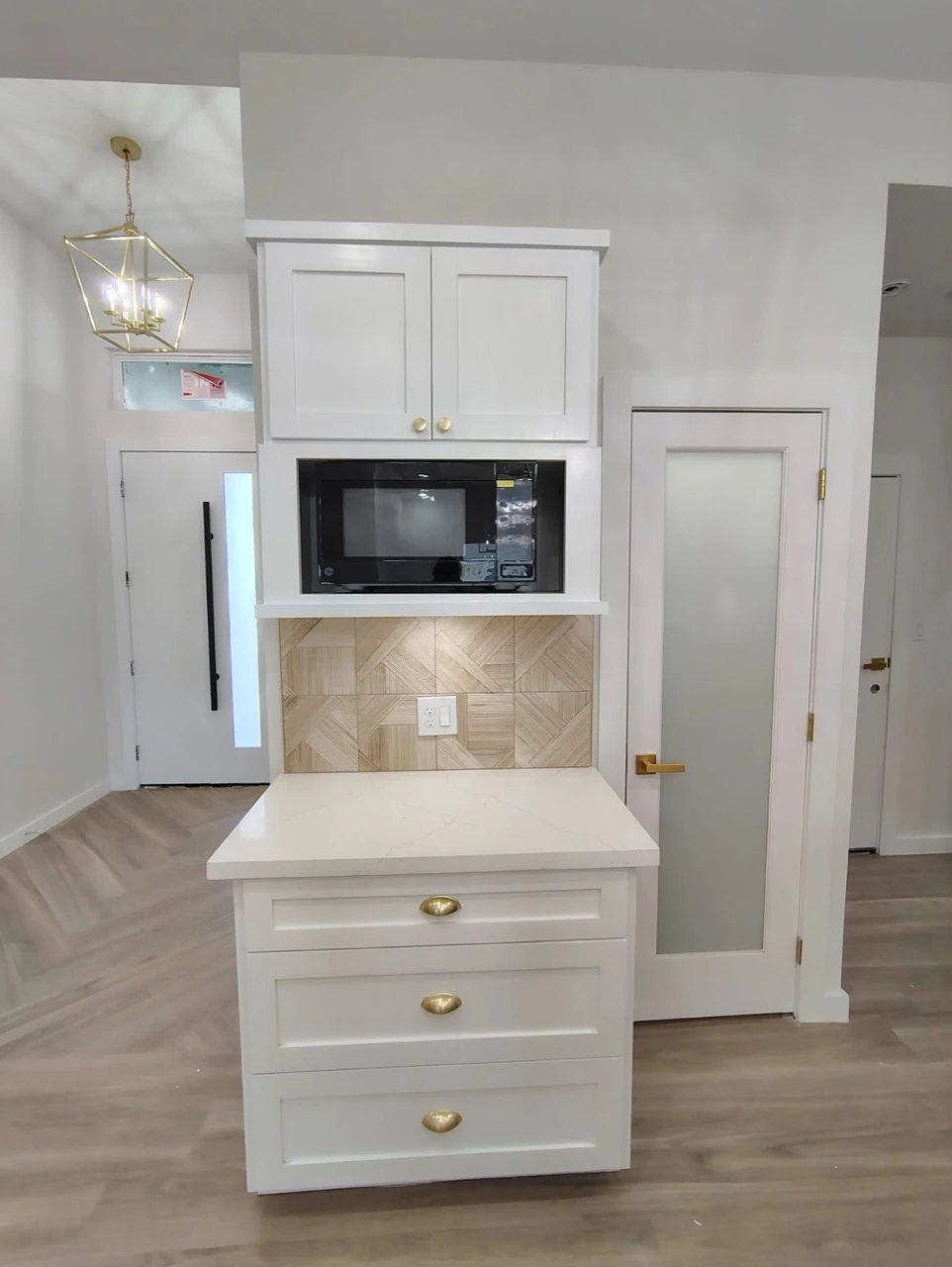 White kitchen cabinetry and appliance area.